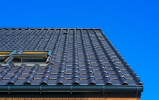 All America Construction Services in South Florida - A picture of vertical low angle closeup shot black roof building